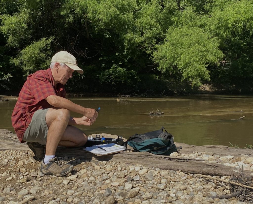 A volunteer monitor tests water chemistry of a stream on the Talladega National Forest. 